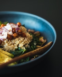 Close-up of a wholesome grain bowl with quinoa, roasted vegetables, and herbs.