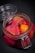A glass jar filled with vibrant pickled vegetables, including sliced beets and a small yellow vegetable, immersed in a deep pink liquid. The jar is sealed with a metal clasp and sits on a dark surface.