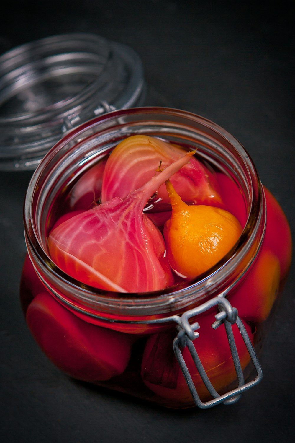 a glass jar filled with fruit and vegetables