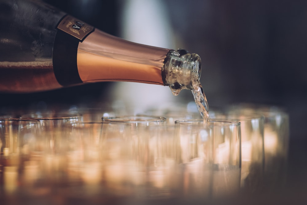 a bottle of champagne being poured into a glass