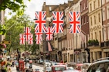 a british flag hanging over a city street