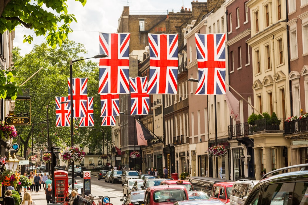 a british flag hanging over a city street