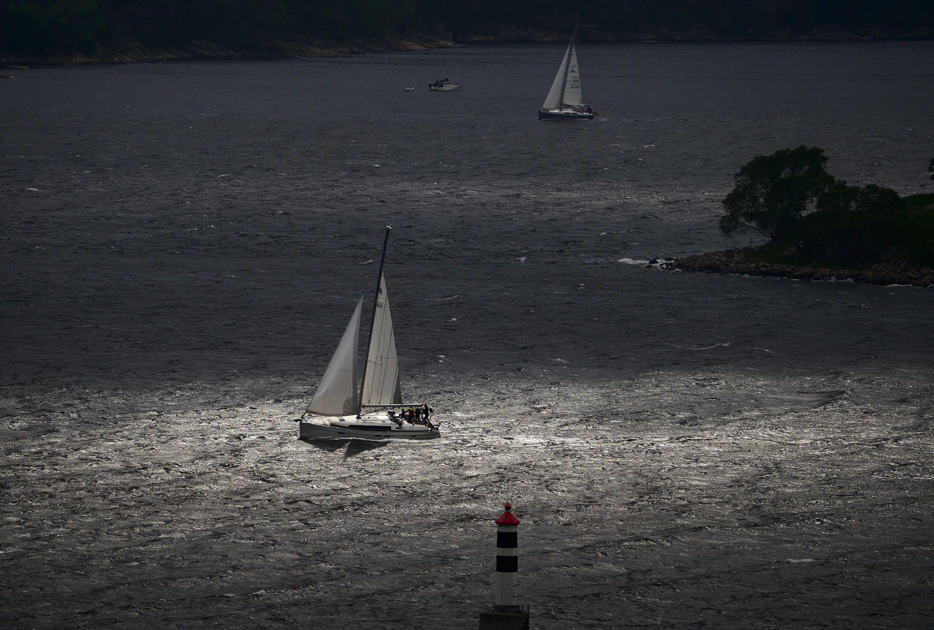 a couple of boats floating on top of a body of water