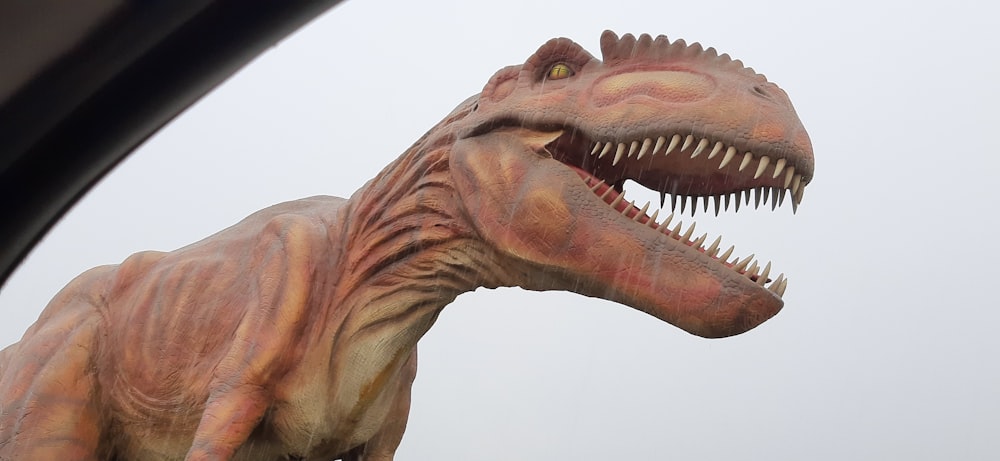 a close up of a dinosaur statue with its mouth open