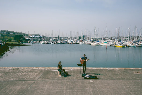 A happy family enjoying music from a marine entertainment system while anchored in a quiet bay.