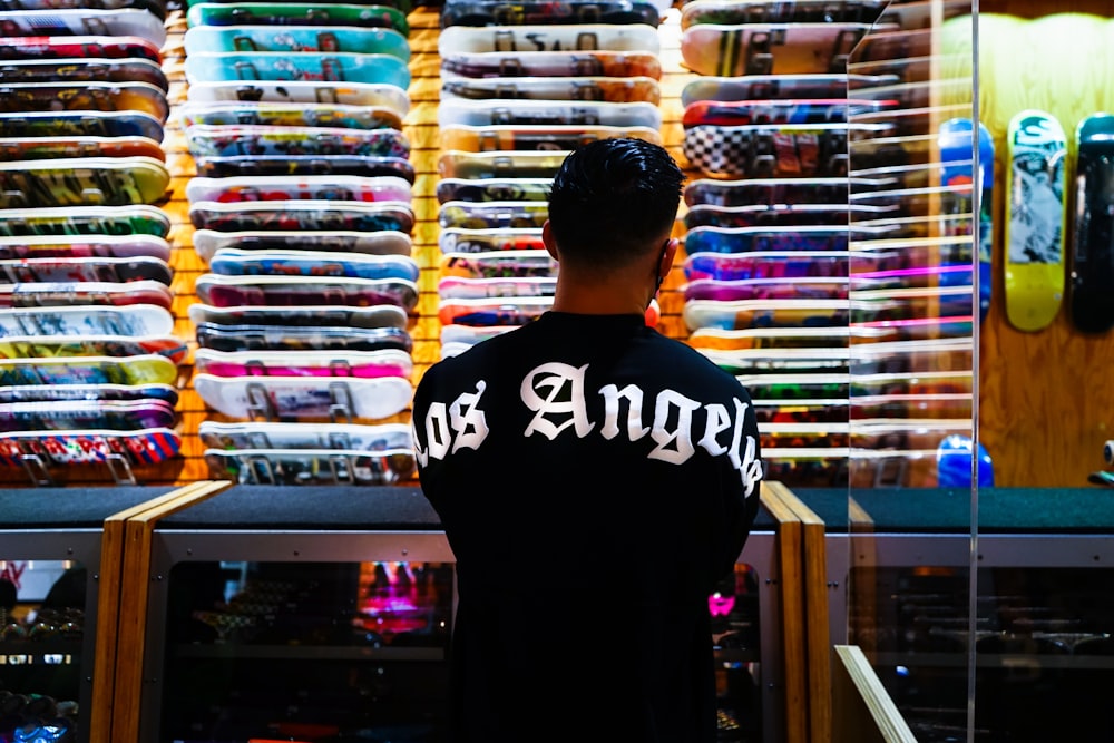 a man standing in front of a display of shirts