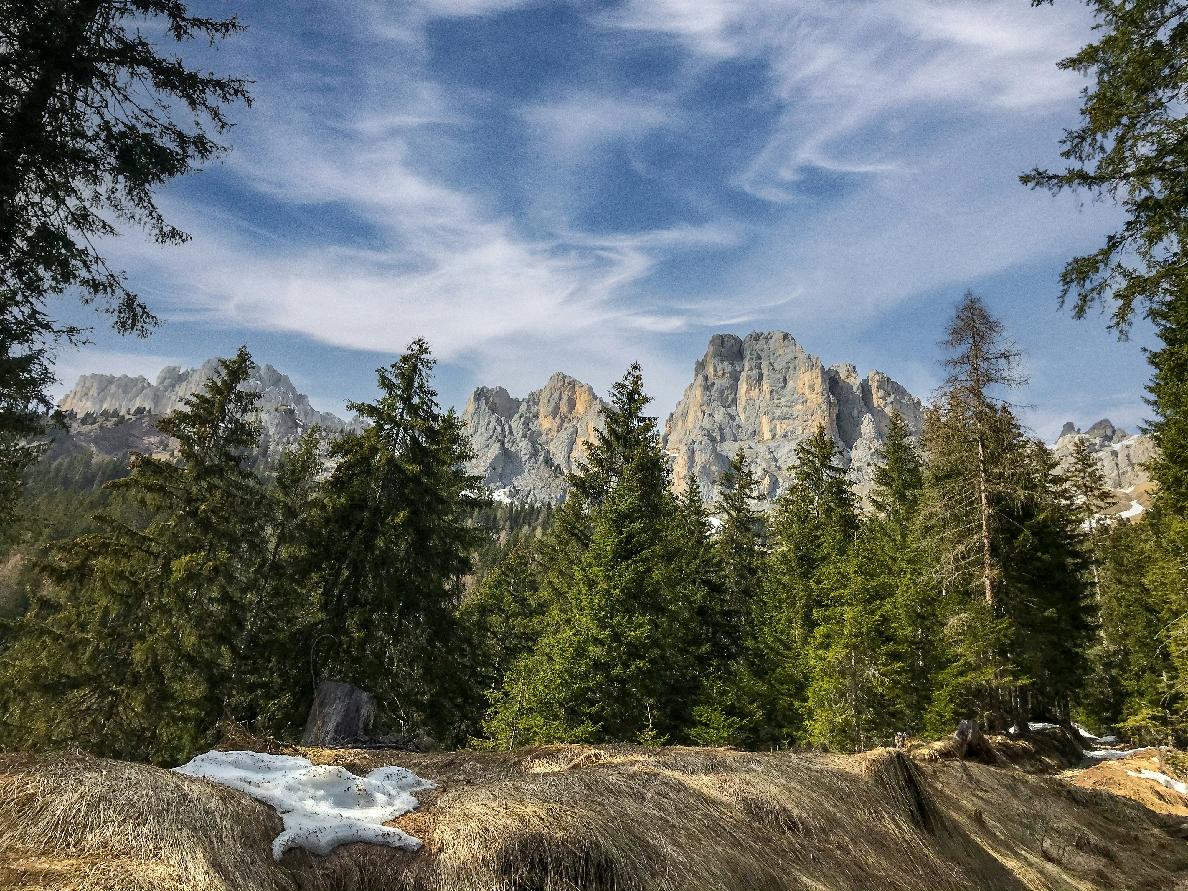 a scenic view of a mountain range with snow on the ground, 