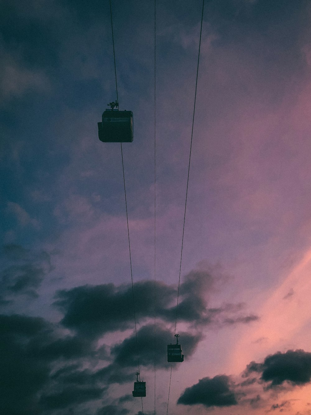 a sky filled with clouds and a ski lift