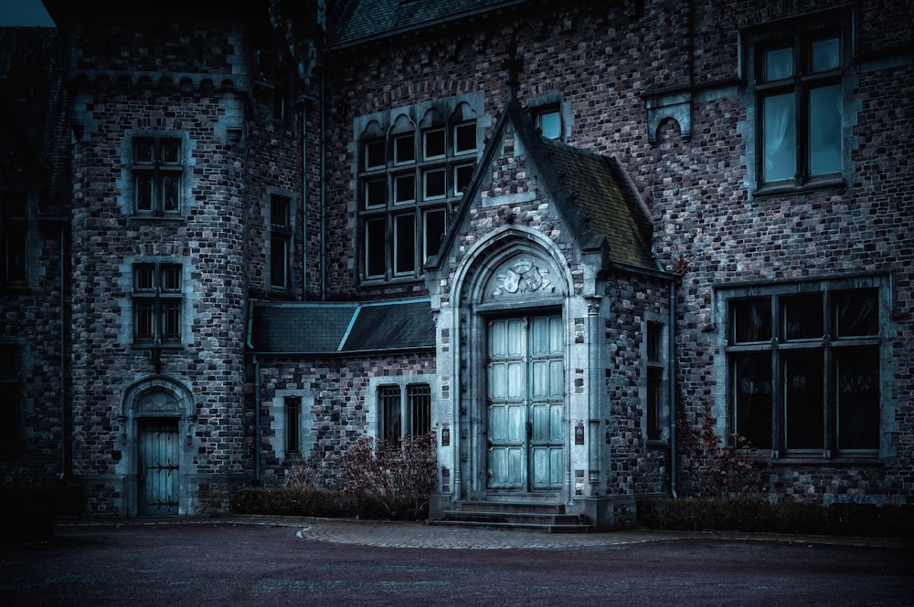 an old brick building with a door and windows