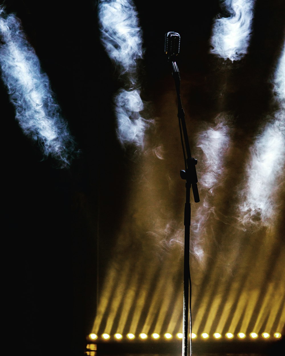 a microphone on a stage with smoke coming out of it