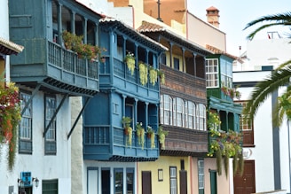 a row of multicolored buildings with balconies