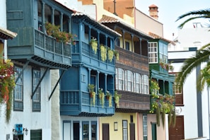 a row of multicolored buildings with balconies