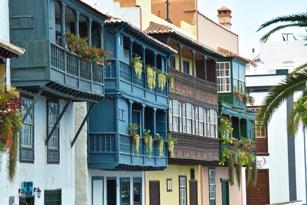 a row of multicolored buildings with balconies