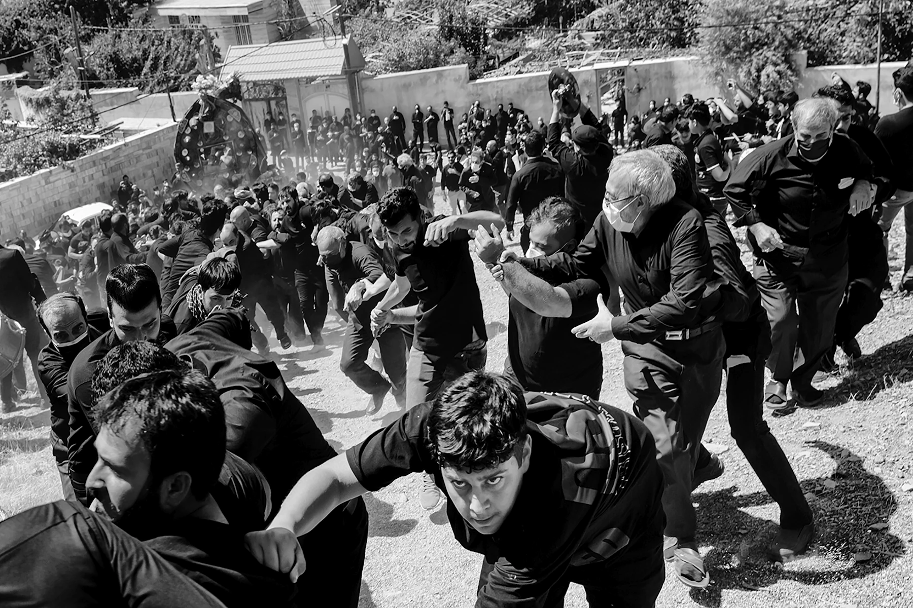 A Large Crowd Moving Together In Black And White