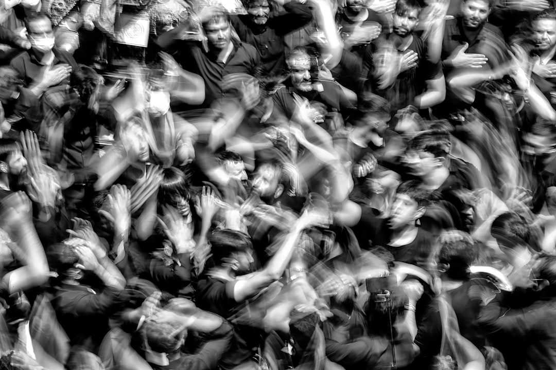 a crowd of people with their hands in the air