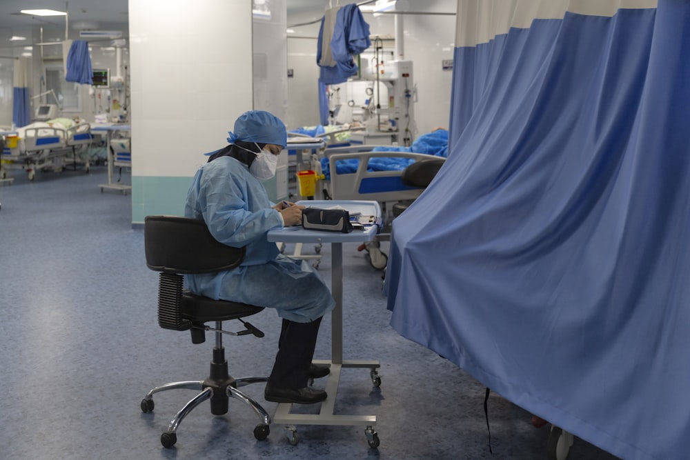 a person sitting at a desk in a hospital