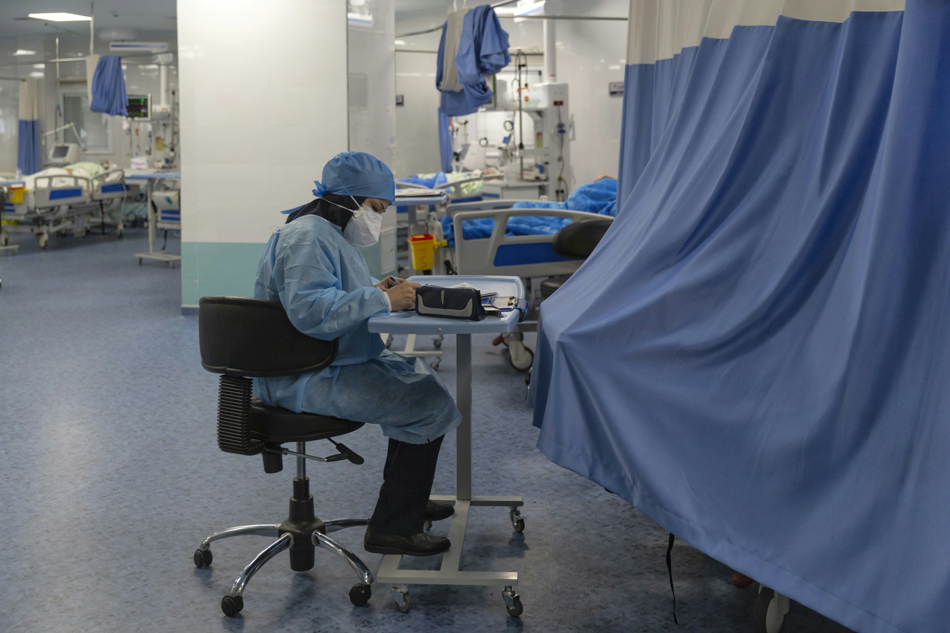 a person sitting at a desk in a hospital