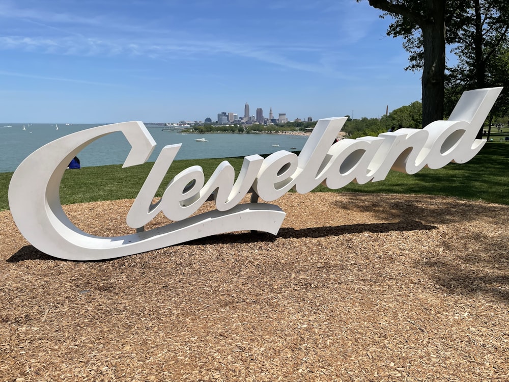 a large sign that says cleveland in front of a lake