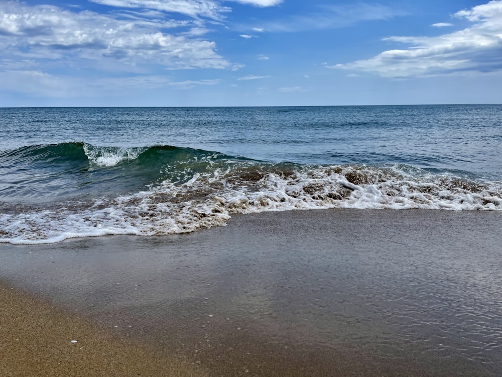 a beach with waves coming in to shore