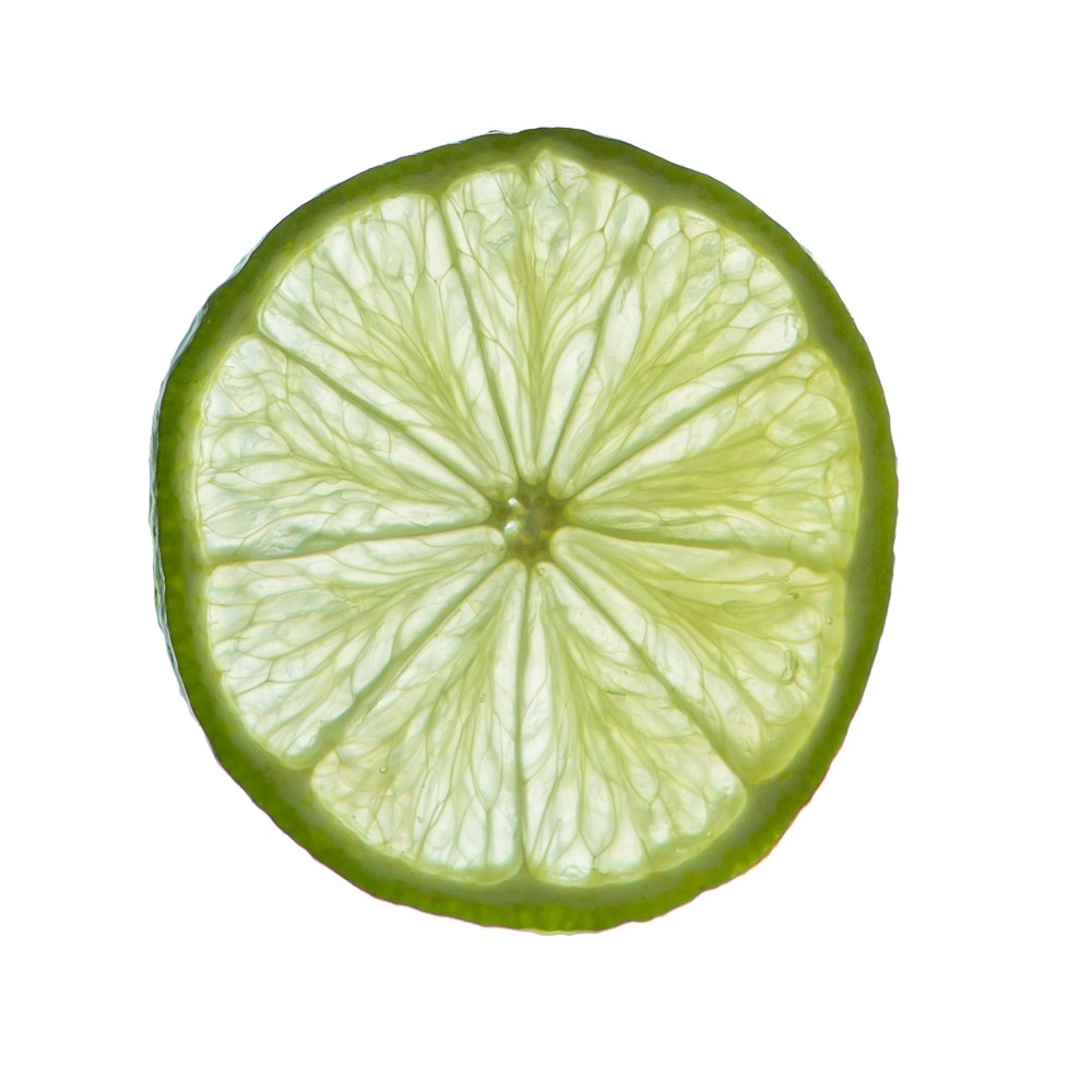 a close up of a lime slice on a white background