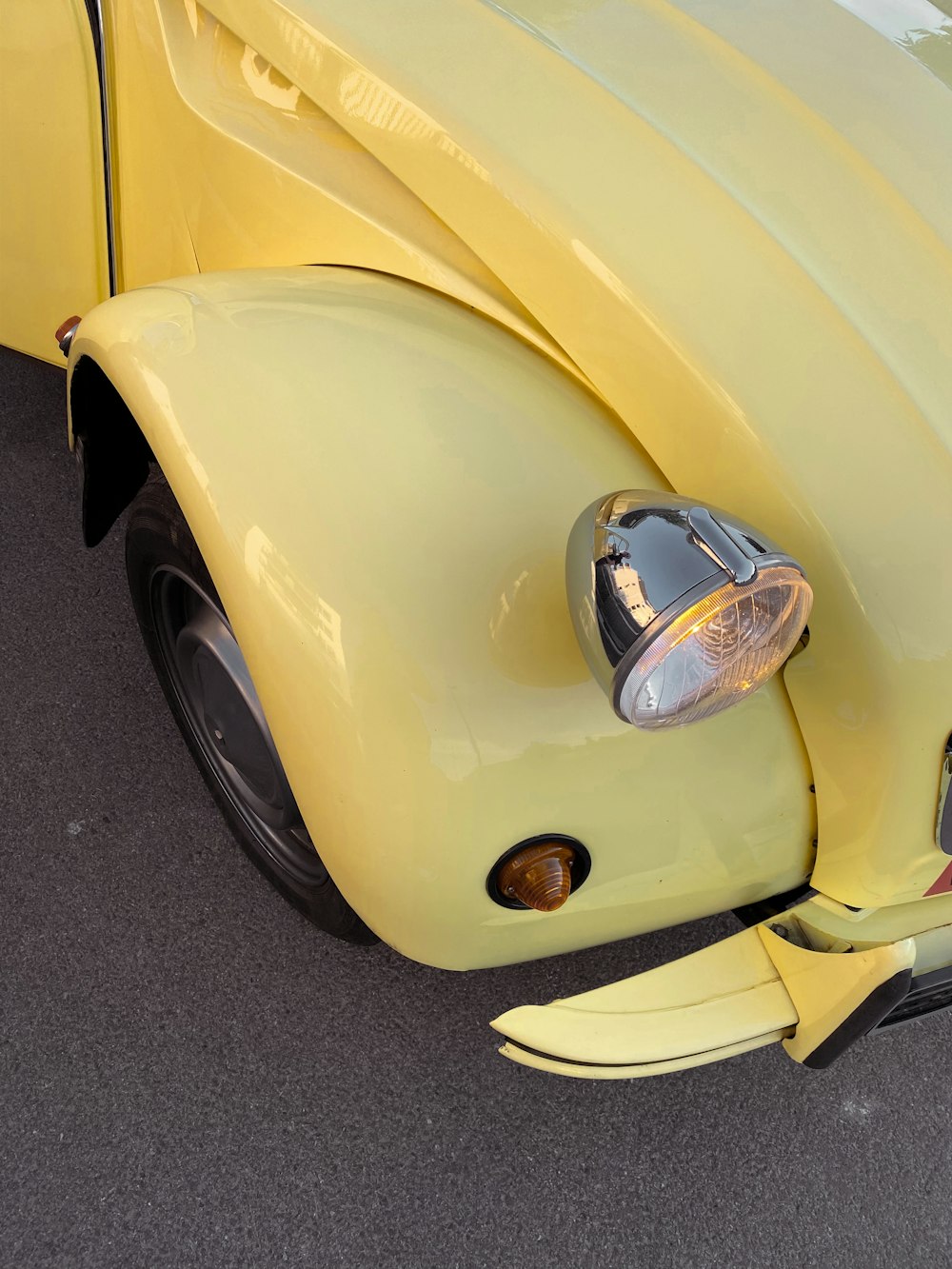 a close up of the front end of a yellow car