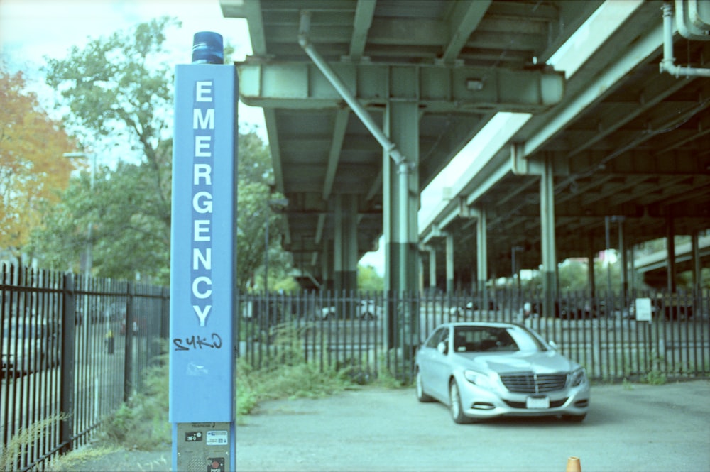 a car is parked in front of a sign