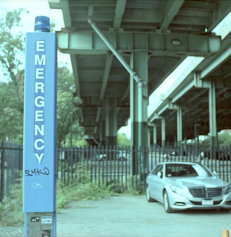 a car is parked in front of a sign