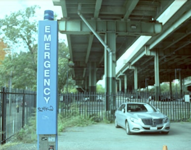 a car is parked in front of a sign