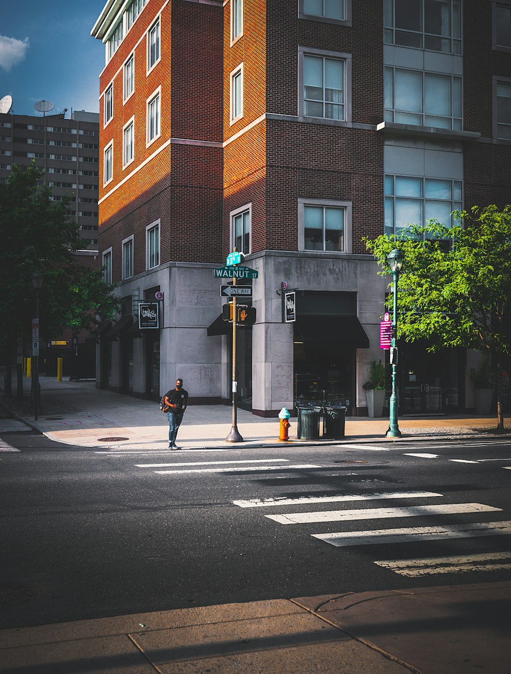 a man crossing a street in front of a tall building