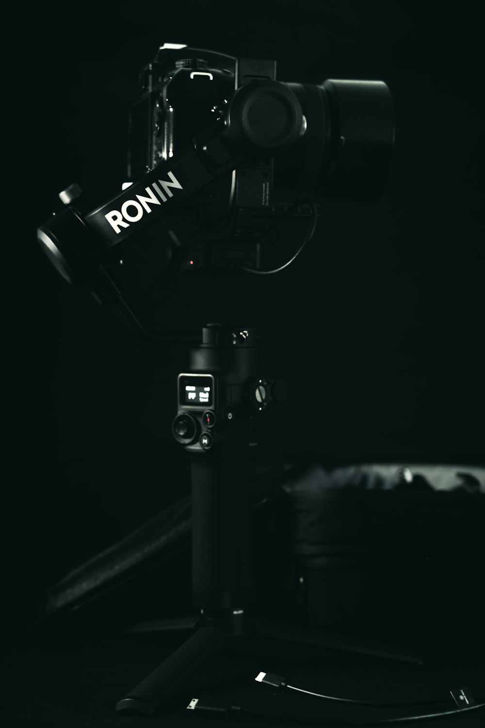 a black and white photo of a camera on a tripod