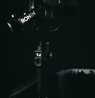 a black and white photo of a camera on a tripod