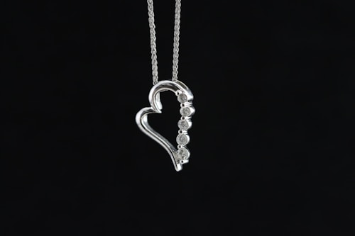 Layered silver necklaces with charms