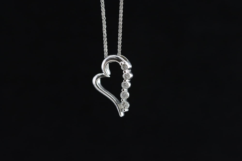 a heart shaped pendant on a black background
