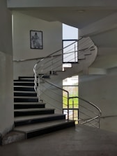 A designer sketch of a modern metal staircase on a drafting table.