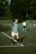 a man standing on a tennis court holding a racquet