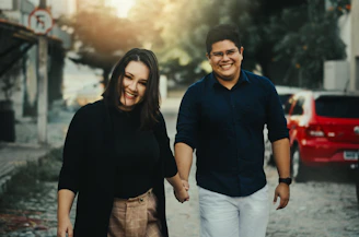 a man and a woman standing in front of a building