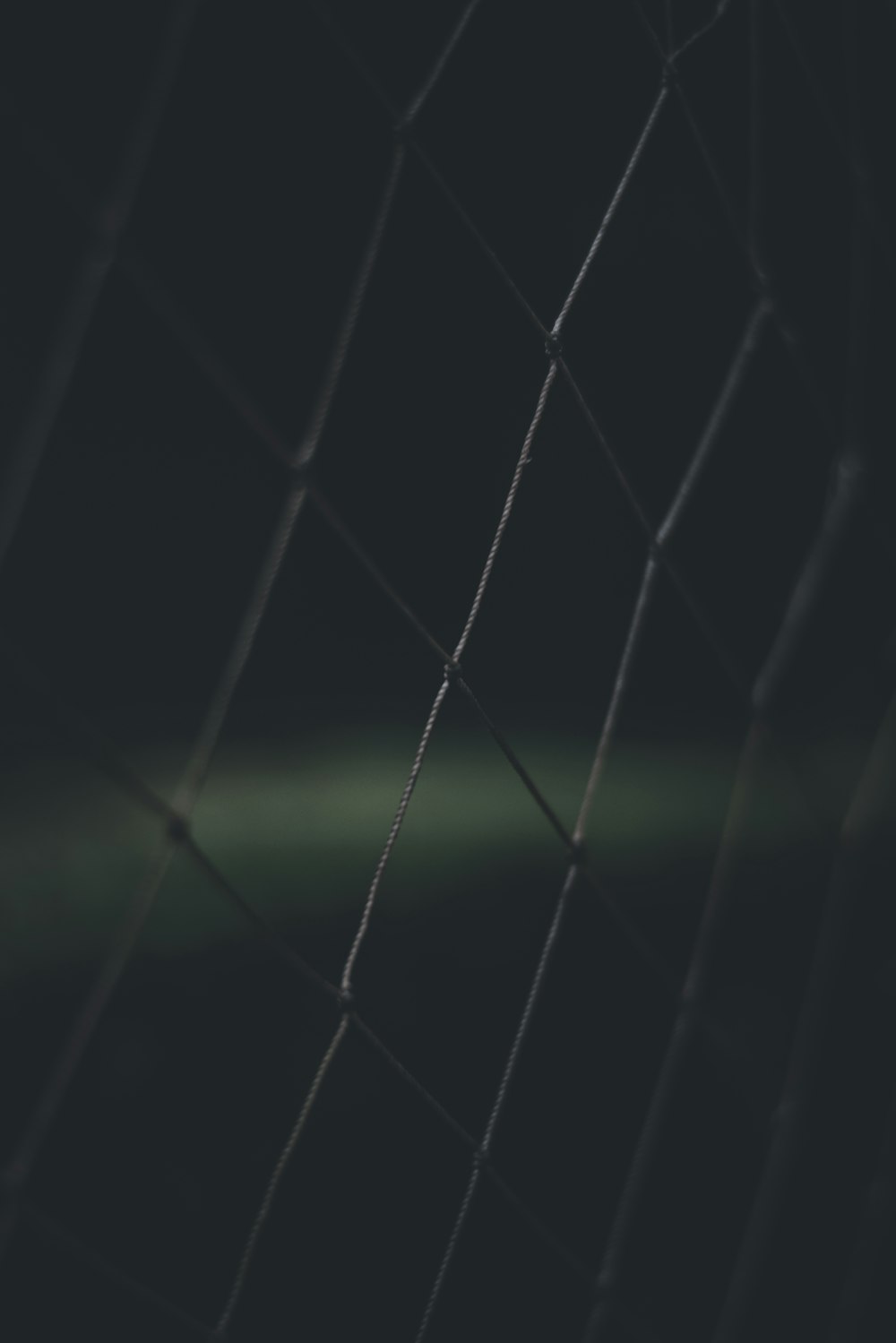 a black and white photo of a wire fence