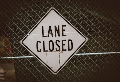 a close up of a street sign on a fence
