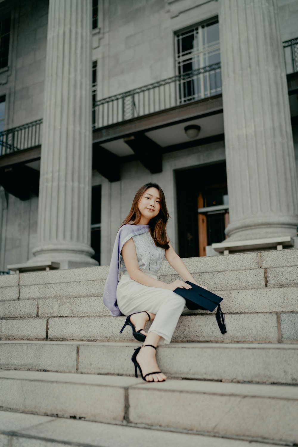 a woman sitting on the steps of a building