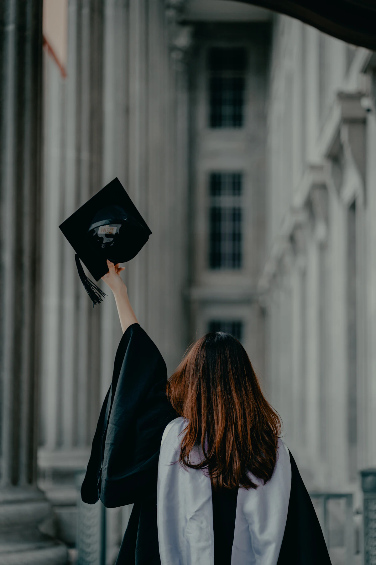 HBCU graduate at campus columns