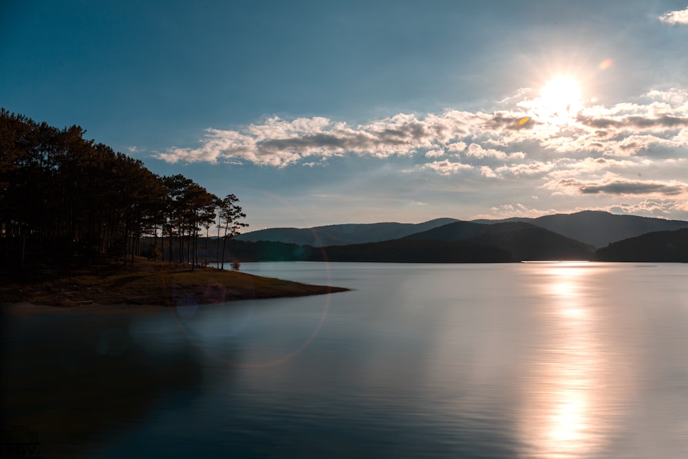 body of water near trees under blue sky during daytime