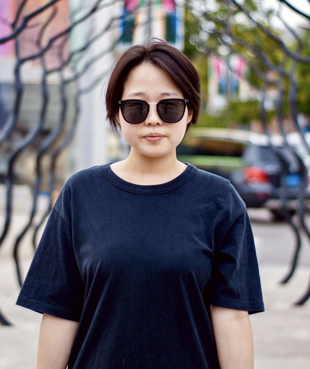 woman in black crew neck t-shirt wearing brown sunglasses