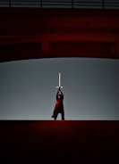 Close-up of a hero character from Skybound Quest wielding a glowing sword against a sunset backdrop.