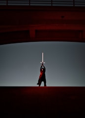 A dynamic scene of a hero wielding a glowing sword amidst a stormy battlefield.