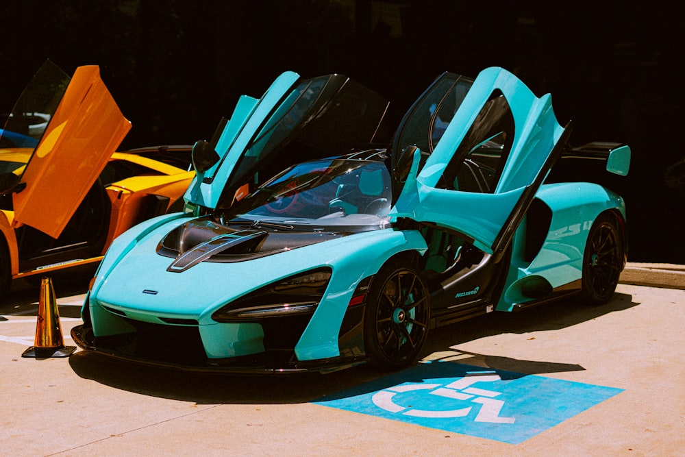 a blue and black sports car parked in a parking lot