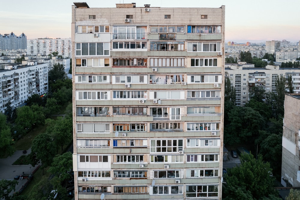 a tall building with lots of windows and balconies