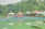 Children playing in the campground pool surrounded by tall trees