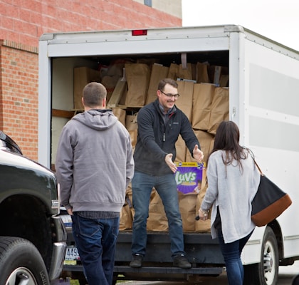 A delivery truck unloading bags of Total Pellets Premium pellets at a customer's home