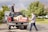Photo of a friendly man in a Chevy Silverado truck loading furniture on a sunny day.