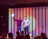 Michael and Kimberly Eaton speaking passionately at a conference podium.